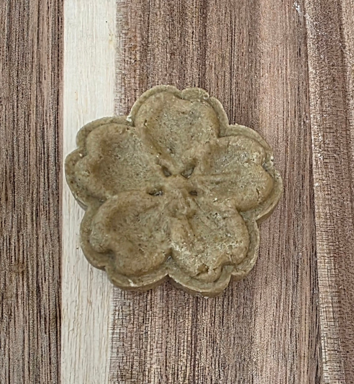 Decorative stone flower on a wooden surface