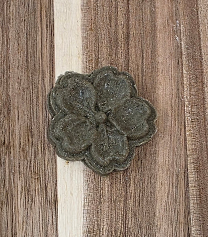 Decorative metal flower on a wooden surface